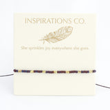 Bracelet with beaded design on a card featuring 'Inspirations Co.' and a feather illustration.