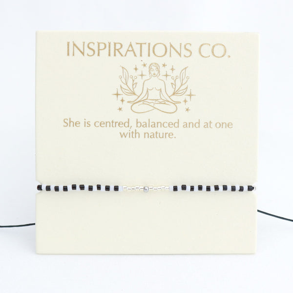 Branding card for Inspirations Co. with a woman in a meditative pose and text on a white background.