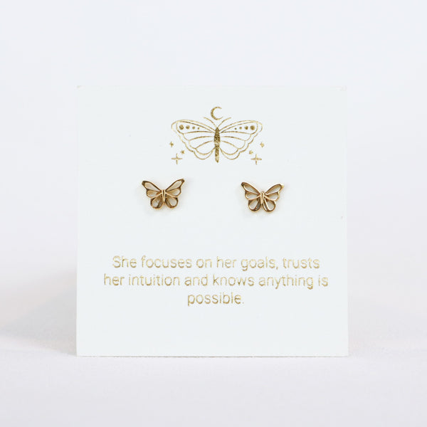 Gold butterfly earrings on a white card with motivational quote