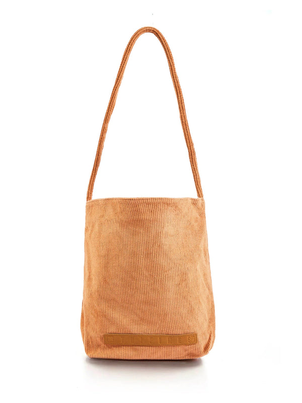 A corduroy tote bag in a dusty blue color with a leather lining, displayed against a white background.