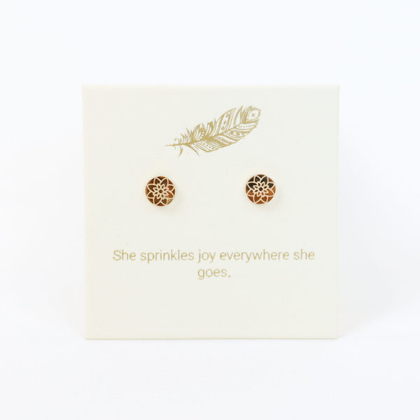 Decorative card with gold designs and text on a white background