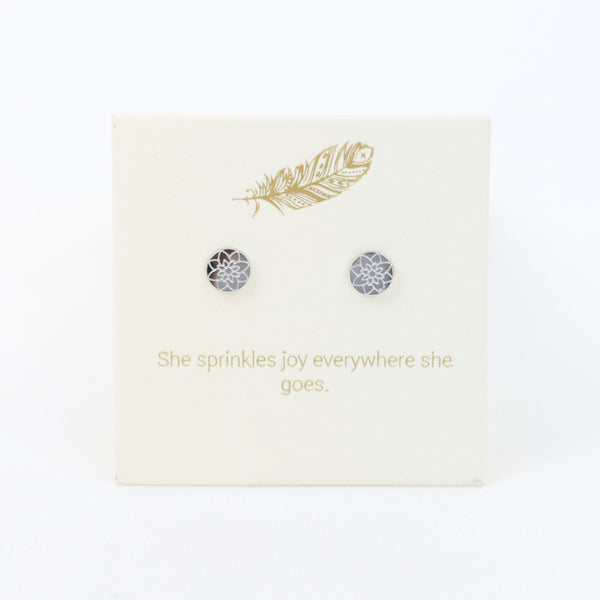 Earring card with earrings and decorative text on a white background