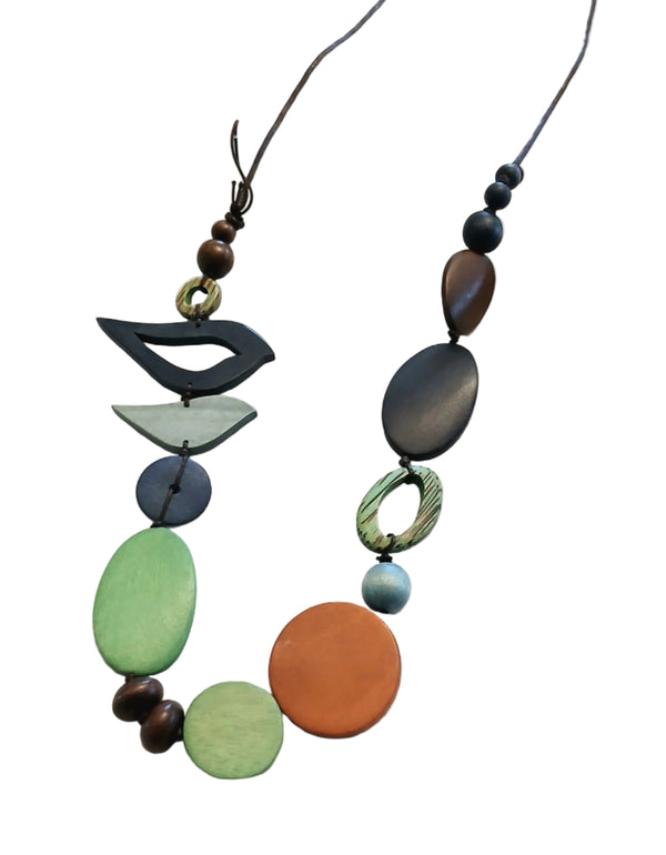 Necklace with colorful beads on a white fabric background