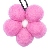 Pink felt balls on a white background