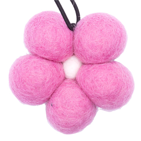 Pink felt balls on a white background