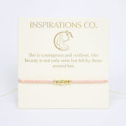 Pink bracelet with gold accents on a card from Inspirations Co.