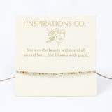 Jewelry card with 'Inspirations Co.' branding and a quote on a white background