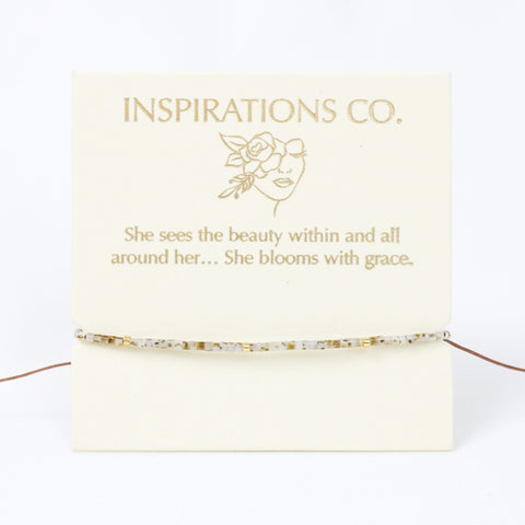 Jewelry card with 'Inspirations Co.' branding and a quote on a white background