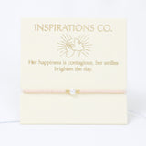 Bracelet with pearl charm on a 'Inspirations Co.' branded card with text.