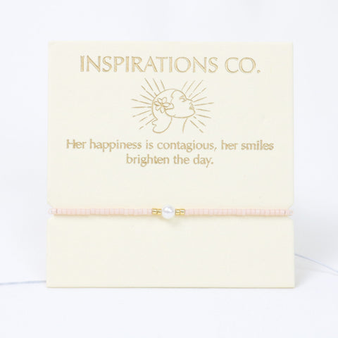 Bracelet with pearl charm on a 'Inspirations Co.' branded card with text.