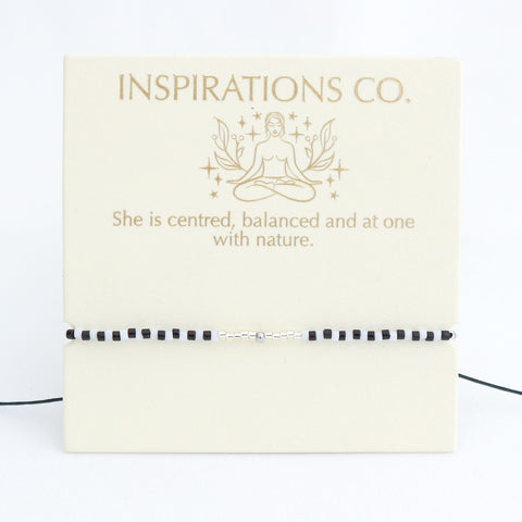 Branding card for Inspirations Co. with a woman in a meditative pose and text on a white background.