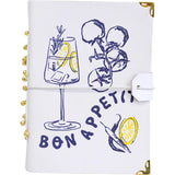 Notebook with 'Bon Appetit' design featuring a glass of water with lemon and rosemary, on a white background.
