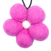 Pink felt ball flower on a white background