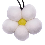 Flower-shaped toy with white petals and a yellow center on a white background