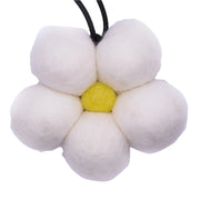 Flower-shaped toy with white petals and a yellow center on a white background