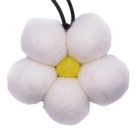 Flower-shaped toy with white petals and a yellow center on a white background