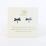 Dragonfly-shaped earrings on a card with a motivational quote