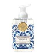 Foaming hand soap bottle with blue and white pattern and gold emblem on a white background