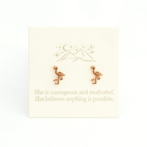Gold flamingo earrings on a white card with motivational text