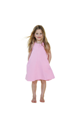 Young girl wearing a pink dress against a light green background