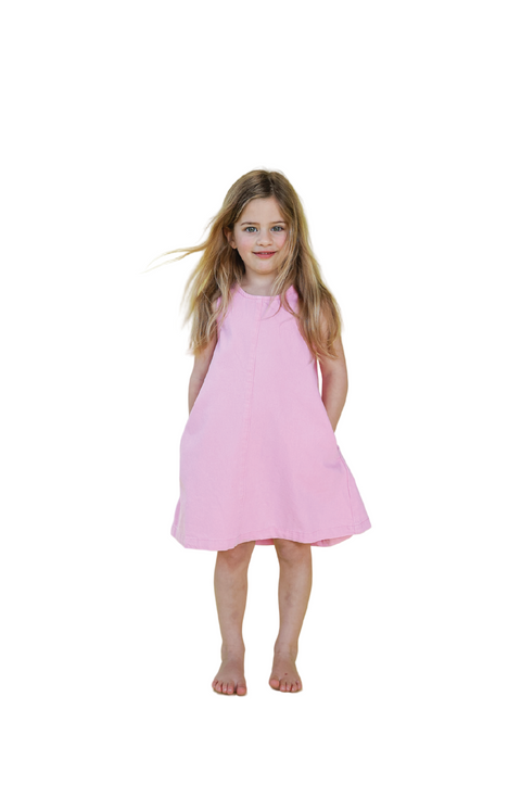 Young girl wearing a pink dress against a light green background