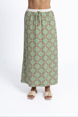 Green patterned skirt worn by a person on a white background