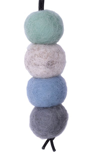 Four felted wool balls in gray, blue, beige, and green on a white background