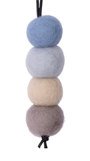 Four felted balls in gray, beige, and blue on a white background
