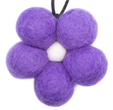 Purple felt balls on a white background