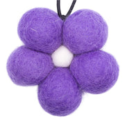 Purple felt balls on a white background