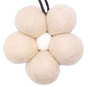 Set of beige felt laundry balls on a white background