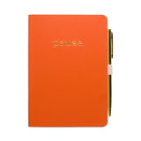 Orange notebook with 'pause' text and a pen on a white background