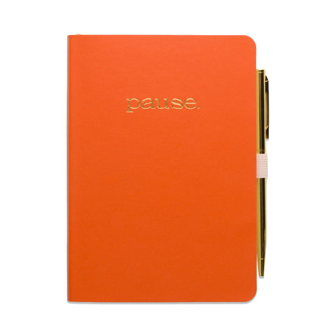 Orange notebook with 'pause' text and a pen on a white background