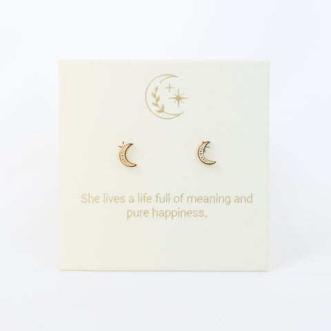 Gold moon-shaped earrings on a card with a motivational quote on a white background