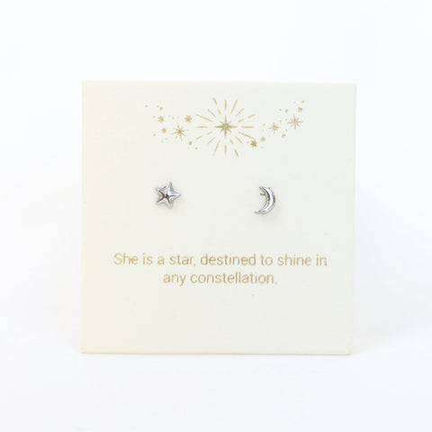 Silver star and moon earrings on a decorative card with gold text and designs.
