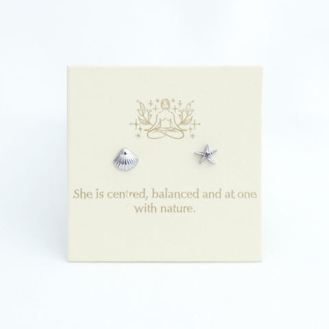 Pair of silver earrings on a card with text and design