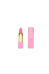 Pink lipstick with gold cap and 'SUZY' packaging on a white background