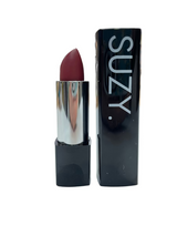 Lipstick with packaging labeled 'SUZY' on a white surface.