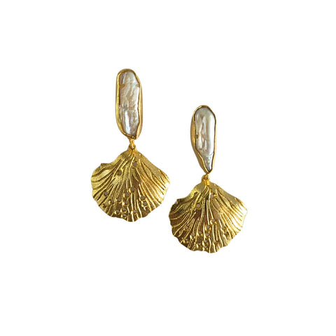 Gold shell-shaped earrings with a white center on a white background