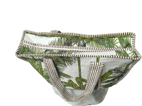 Tropical leaf-patterned bag on a light gray floor