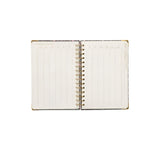 Open planner with spiral binding on a white background