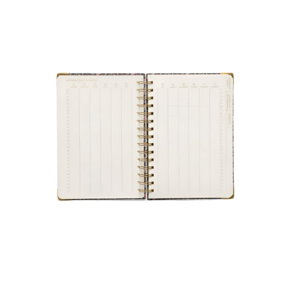 Open planner with spiral binding on a white background