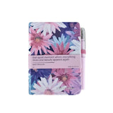 Floral notebook with a pen on a white background