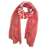 Red patterned scarf draped over a white surface