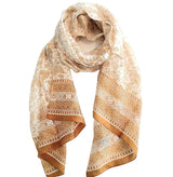 Beige patterned scarf on a white surface