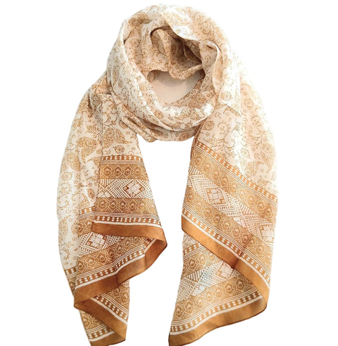 Beige patterned scarf on a white surface