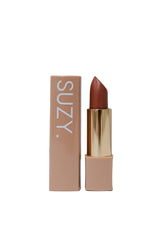 Lipstick with gold cap and 'SUZY' branding on a gray background